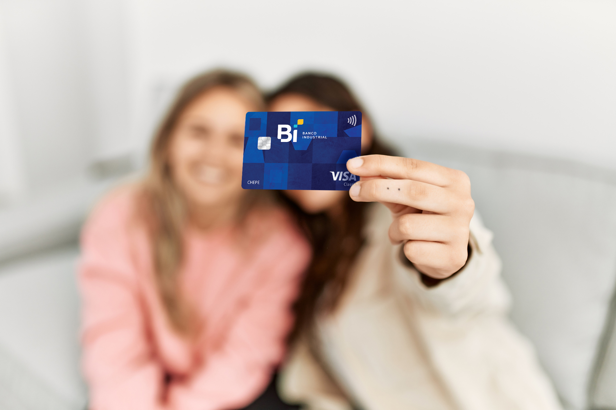 Young couple smiling happy holding credit card at home.